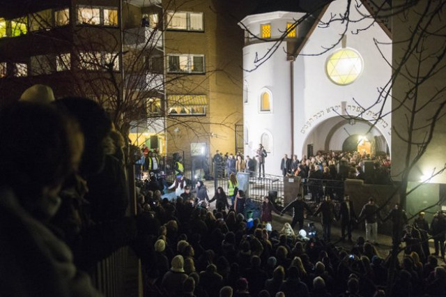 people gather as norwegian muslims create a human peace ring around the synagogue in oslo norway on february 21 2015 photo afp people gather as norwegian muslims create a human peace ring around the synagogue in oslo norway on february 21 2015 photo afp