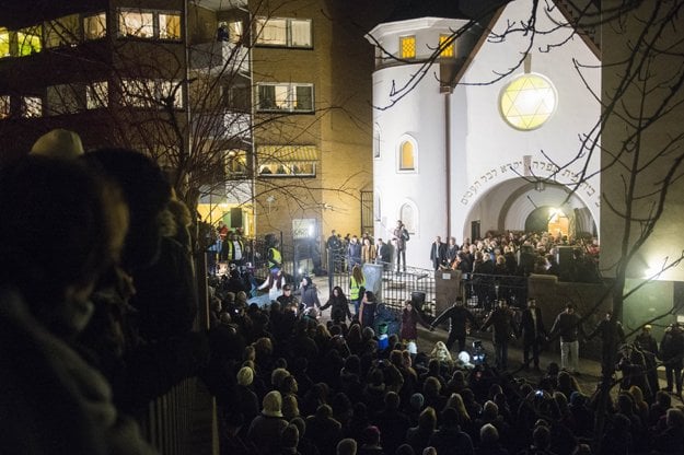 people gather as norwegian muslims create a human peace ring around the synagogue in oslo norway on february 21 2015 photo afp