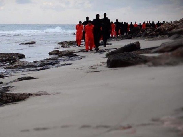 an image grab taken from a video released by is militant media arm al hayat media centre on february 15 2015 purportedly shows black clad islamic state is group fighters leading handcuffed hostages said to be egyptian coptic christians wearing orange jumpsuits before their alleged decapitation on a seashore in the libyan capital of tripoli photo afp an image grab taken from a video released by is militant media arm al hayat media centre on february 15 2015 purportedly shows black clad islamic state is group fighters leading handcuffed hostages said to be egyptian coptic christians wearing orange jumpsuits before their alleged decapitation on a seashore in the libyan capital of tripoli photo afp