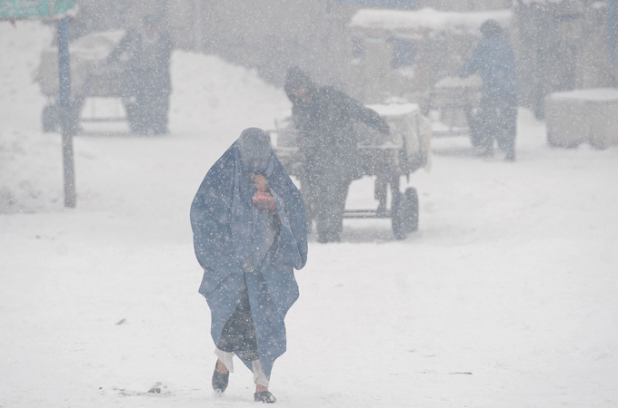 file photo of a woman struggling to make her way through the snow covered streets of kabul photo afp