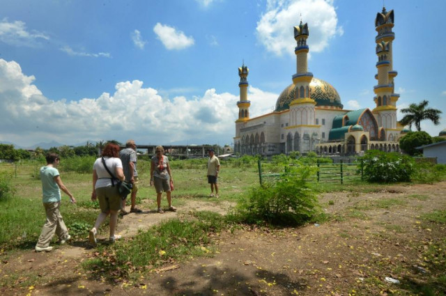 tourists visit an islamic centre in mataram on the island of lombok in indonesia tourists visit an islamic centre in mataram on the island of lombok in indonesia