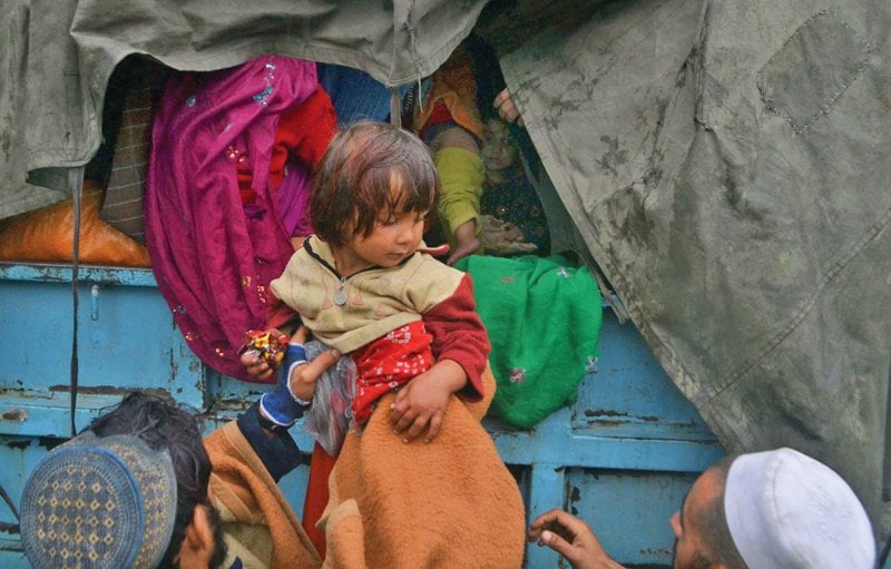 an afghan girl is among one of several refugees put on a truck at the unhcr office on chamkani road and sent to her home country photo inp