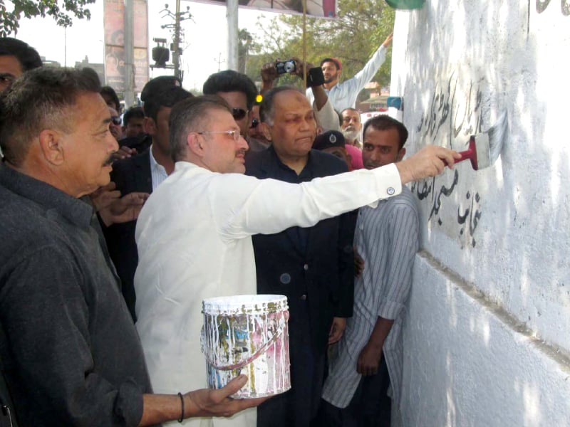 sharjeel memon removes wall chalking during the clean karachi campaign photo ppi