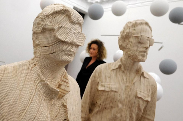 a sculpture of daft punk by xavier veilhan is on display before the opening of an exhibition at the galerie perrotin in new york marking the first time the duo have intentionally been depicted without their trademark helmets february 26 2015 photo afp