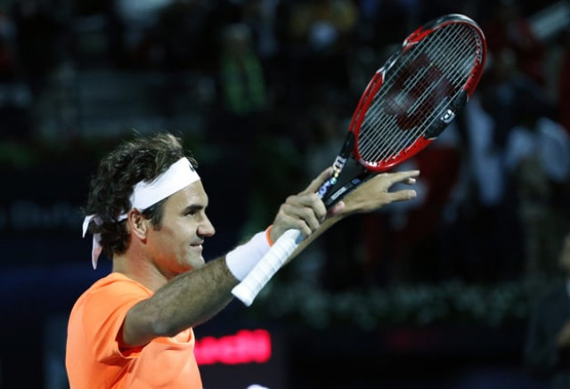 roger federer of switzerland gestures to the crowd after defeating world number one novak djokovic of serbia during their final match on the fifth day of the atp dubai duty free tennis championships on february 28 2015 in dubai photo afp