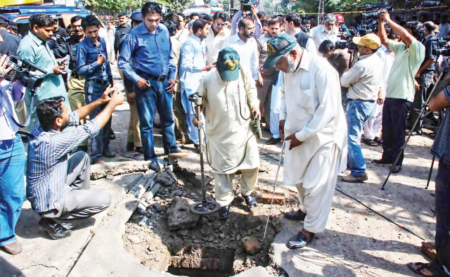 extensive coverage civil defence workers examine a damaged manhole while a crowd of media personnel look on photo express abid nawaz extensive coverage civil defence workers examine a damaged manhole while a crowd of media personnel look on photo express abid nawaz