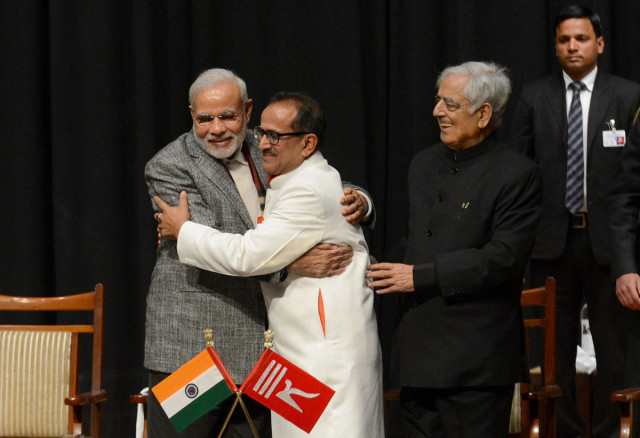 indian prime minister narinder modi l and jammu and kashmir deputy chief minister nirmal singh c embrace as jammu and kashmir chief minister mufty mohammed sayeed r looks on during a swearing in ceremony of the state assembly in jammu on march 1 2015 photo afp