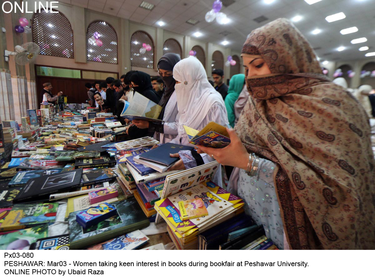 women taking keen interest in books during the book fair at pu photo online