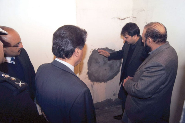 home secretary sibtain ahmed shows the hole through which the prisoners fled the jail photo courtesy sajjadul haq home secretary sibtain ahmed shows the hole through which the prisoners fled the jail photo courtesy sajjadul haq