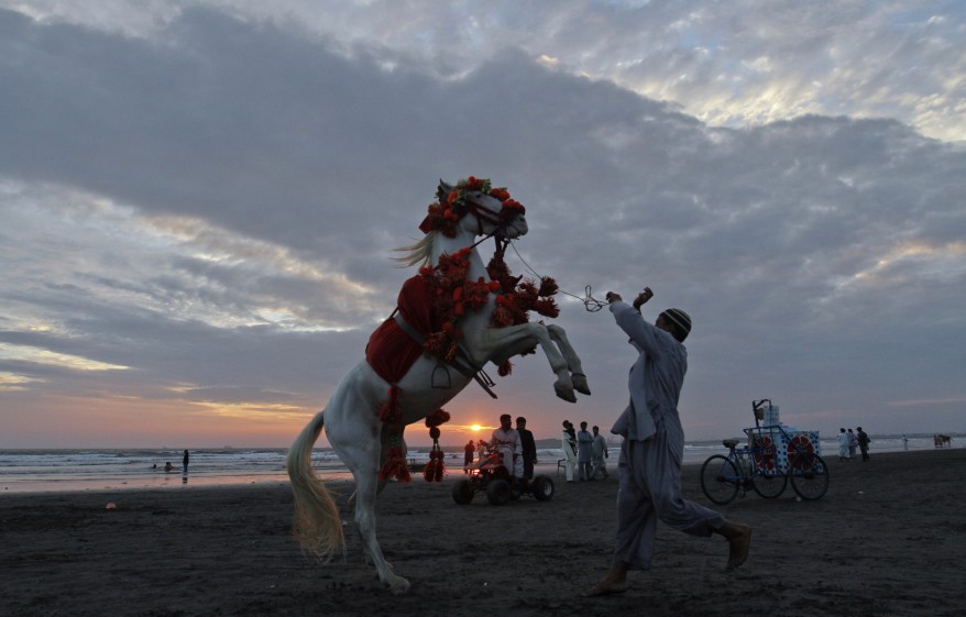 a man and his decorated horse on clifton beach in karachi pakistan photo reuters