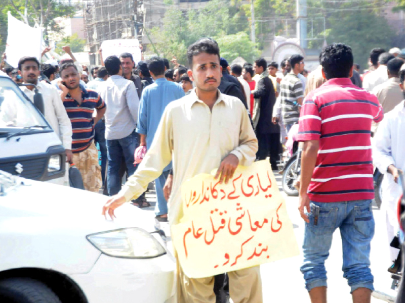 shopkeepers and traders belonging to lyari shut down their businesses on wednesday and staged a protest outside the sindh assembly against extortion and karachi s law and order situation photo rashid ajmeri express