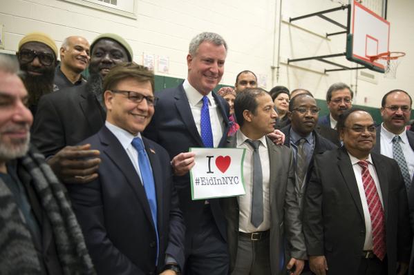 new york 039 s mayor holds up a i love eidinnyc poster after announcing a change in school calendars to accomodate the holiday photo billdeblasio