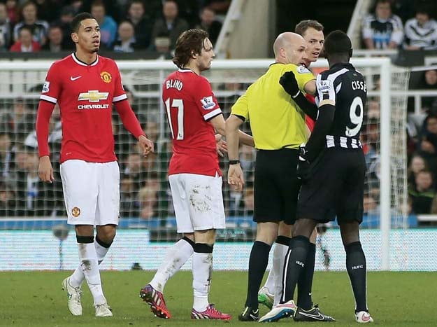 manchester united defender johnny evans got involved in a spit row with newcastle forward papiss cisse as the northern irishman appeared to spit on the senegalese as he was getting off the turf for which the striker responded in kind photo afp