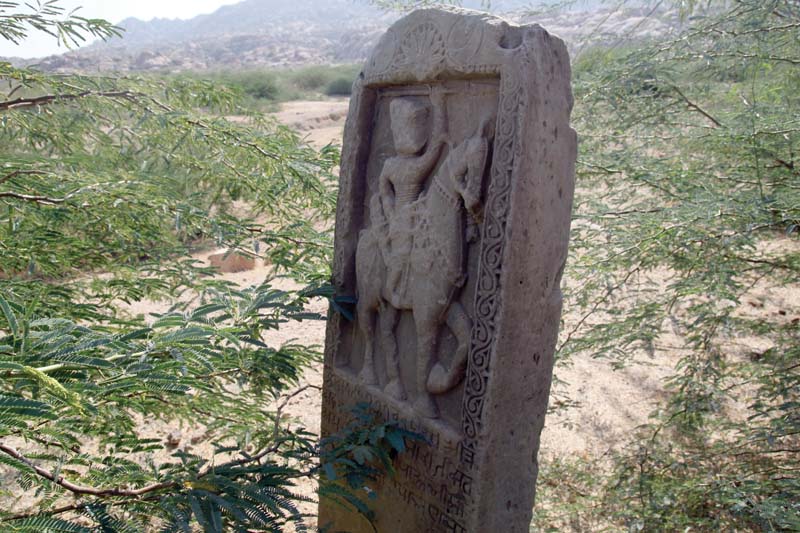 a memorial stone depicting man riding on a horse of a likely royal figure whose wife committed self immolation in tharparkar photo shahzeb ahmed express