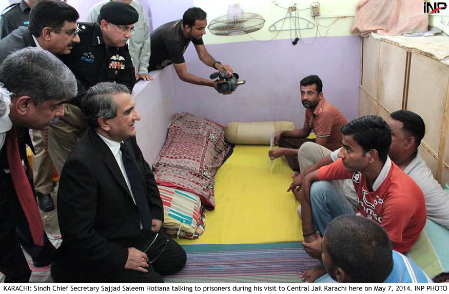 sindh chief secretary sajjad saleem hotiana speaks with prisoners during a visit to the central jail in karachi photo inp