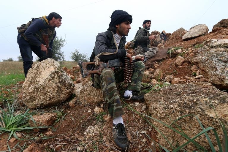 fighters from the al nusra front al qaeda 039 s syria branch hold a position near syria 039 s northern city of aleppo as they fight against forces loyal to the regime on december 19 2014 photo afp