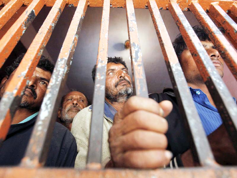 fishermen from india stand behind bars in a cell at a police station in karachi photo reuters