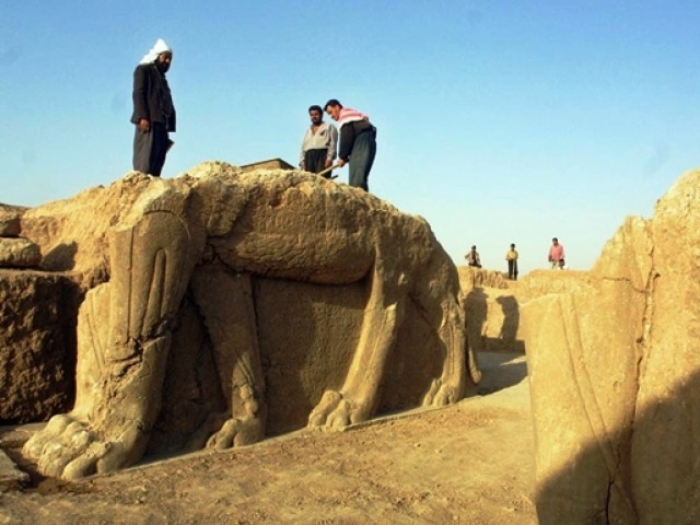 a file picture taken on july 17 2001 shows iraqi workers cleaning a statue of winged bull at an archeological site in nimrud photo afp