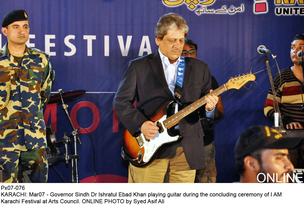 sindh governor dr ishratul ebad playing the guitar during the closing ceremony of the i am karachi festival photo online