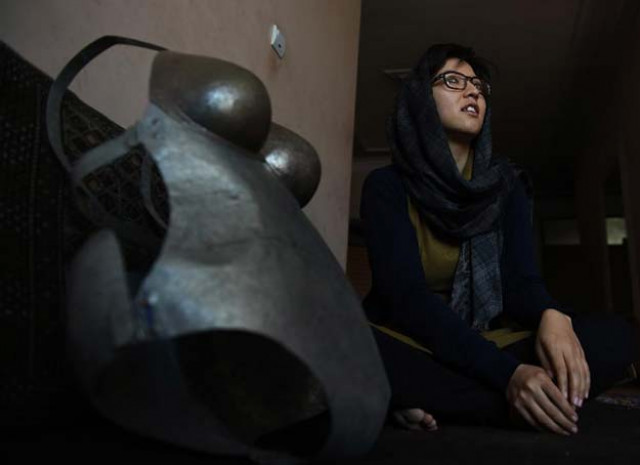 afghan artist kubra khademi 27 sits alongside a suit of armour she made as a protest against sexual harrassment during an interview with afp in kabul on march 8 2015 photo afp afghan artist kubra khademi 27 sits alongside a suit of armour she made as a protest against sexual harrassment during an interview with afp in kabul on march 8 2015 photo afp