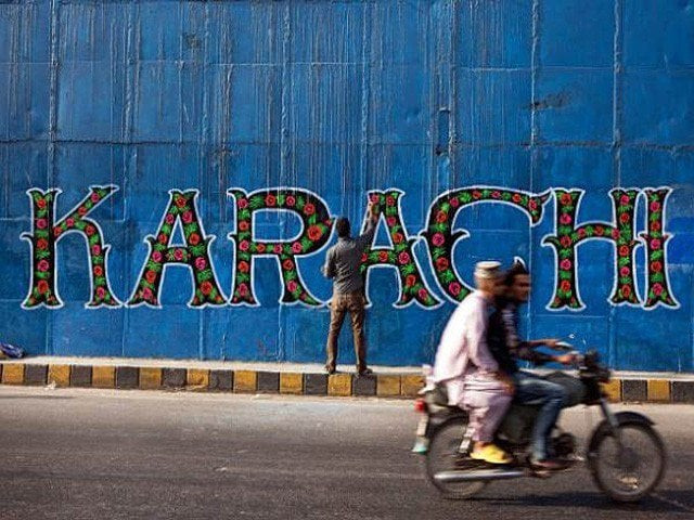 a street artist applies the final touches to a mural part of the 039 i am karachi 039 campaign as a motorcycle passes by in karachi photo getty a street artist applies the final touches to a mural part of the 039 i am karachi 039 campaign as a motorcycle passes by in karachi photo getty