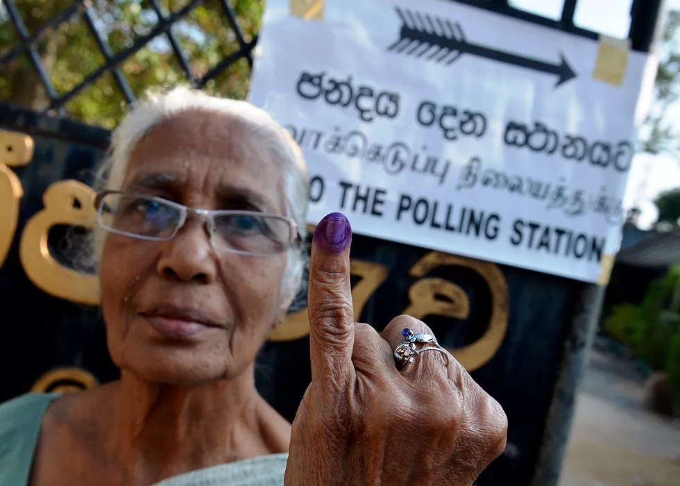 a sri lankan woman holds up her inked finger after voting in the country 039 s election at a polling station in the north central town of polonnaruwa some 240 kms from colombo on january 8 2015 photo afp a sri lankan woman holds up her inked finger after voting in the country 039 s election at a polling station in the north central town of polonnaruwa some 240 kms from colombo on january 8 2015 photo afp