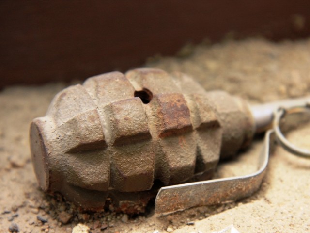 the hand grenade was thrown at his home and landed on the roof stock image