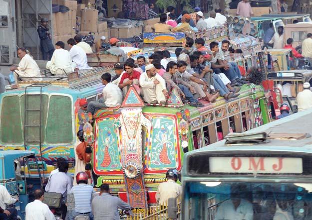 commuters piled on top of buses is a common sight on the roads of karachi photo file