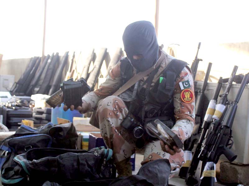 a rangers official shows the arms and ammunitions recovered during the raid photo ppi