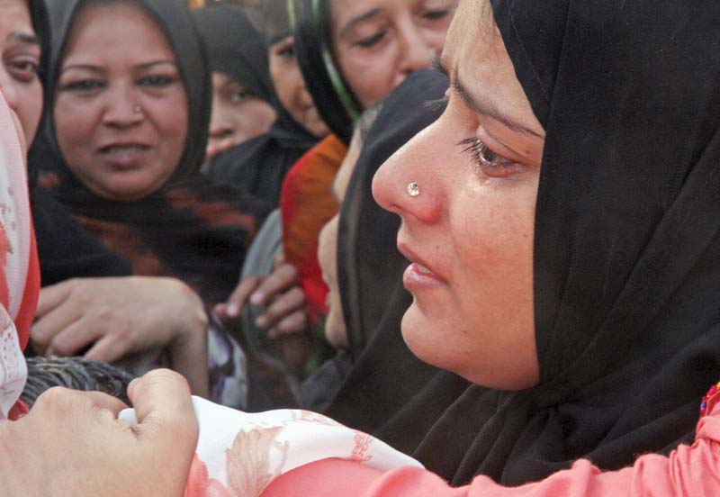 the sister in law of deceased mqm worker waqas shah weeps at his funeral photo athar khan express