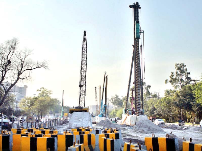 very much present cranes on the construction site opposite siddiq trade centre photo abid nawaz express