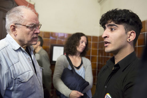 young homosexual lebanese immigrant identified only by his first name nasser speaks to german filmmaker and gay activist rosa von praunheim l in the district court tiergarten in berlin march 12 2015 photo afp