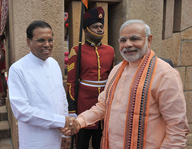 in this handout photograph received from the press information bureau pib on march 13 2015 indian prime minister narendra modi r shakes hands with sri lanka president maithripala sirisena at the ceremonial reception in colombo photo afp