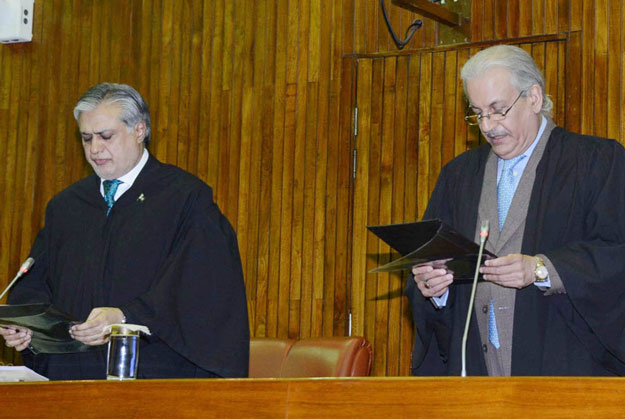 finance minister ishaq dar l administrating the oath of the office of senate chairman to senator raza rabbani photo pid