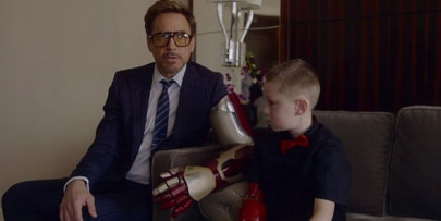 robert downey jr presents iron man arm to disabled boy