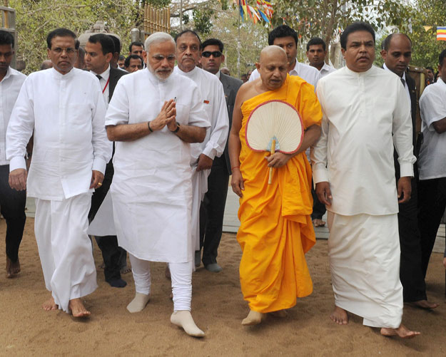 in this handout photograph received from the press information bureau pib on march 14 2015 indian prime minister narendra modi 2l and sri lankan president maithripala sirisena l offer prayers at the sri maha bodhi tree in anuradhapura photo afp