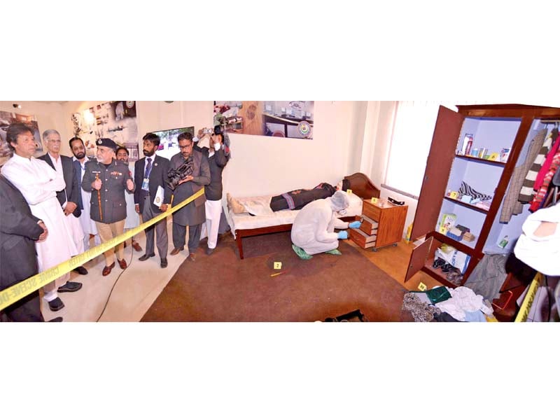 pti chairman imran khan and cm pervez khattak view a crime scene demo at school of investigation in hayatabad photo courtesy press secretary k p cm