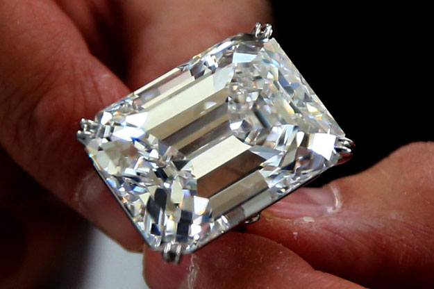 a sotheby 039 s employee shows a 100 2 carat diamond in a classic emerald cut during a preview organised by the action house before the jewel goes under the hammer on march 16 2015 in dubai photo afp