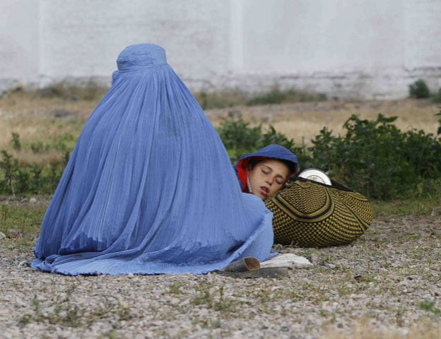 an afghan refugee woman clad in a burqa sits with her sleeping boy as they wait with others to be repatriated to afghanistan at the united nations high commissioner for refugees unhcr office on the outskirts of peshawar february 2 2015 photo reuters an afghan refugee woman clad in a burqa sits with her sleeping boy as they wait with others to be repatriated to afghanistan at the united nations high commissioner for refugees unhcr office on the outskirts of peshawar february 2 2015 photo reuters