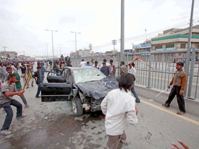 protesters smash a car as violent protests continued for the second day in lahore photo abid nawaz express