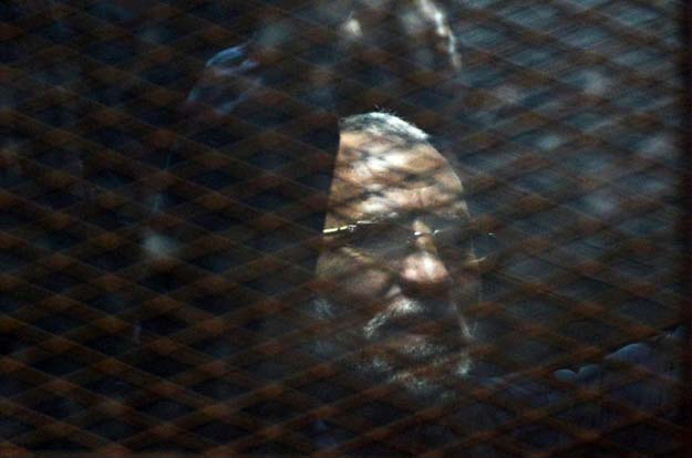 egyptian muslim brotherhood leader mohamed badie stands behind bars during his trial in the capital cairo on february 28 2015 photo afp