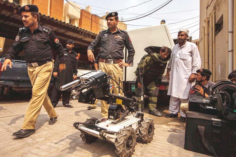 assistant inspector general of police shafqat malik watches members of the bomb disposal squad display their equipment photo reuters