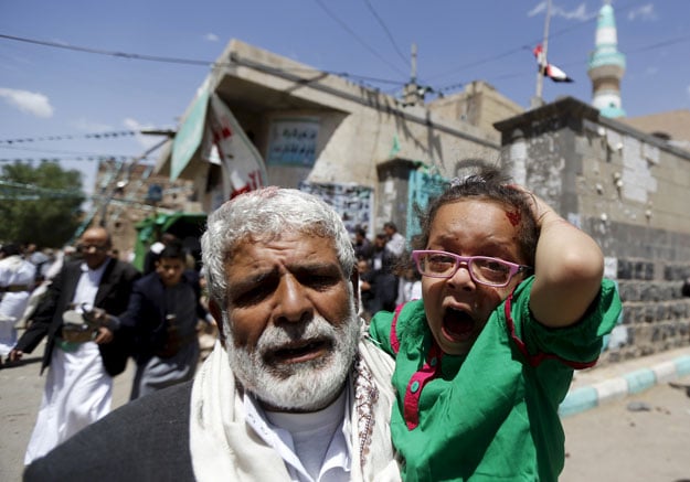 an injured girl reacts as she is carried by a man out of a mosque which was attacked by a suicide bomber in sanaa march 20 2015 photo reuters