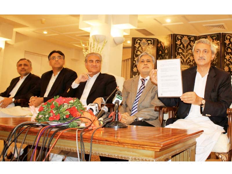 pti leader jahangir tareen holds up a copy of the agreement at a news conference photo inp