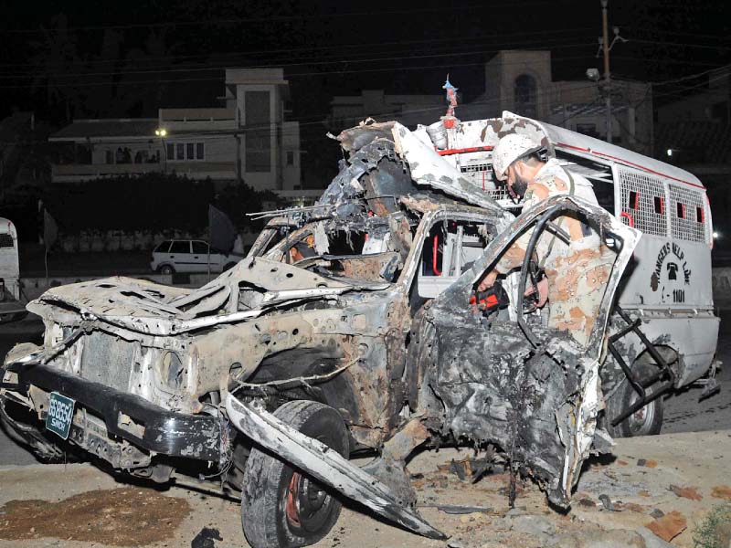 a rangers official inspects the vehicle that came under attack in the north nazimabad neighbourhood karachi photo mohammad noman express