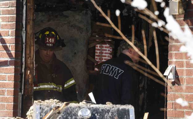 firefighters inspect a home fire in the midwood neighborhood in brooklyn on march 21 2015 in new york city seven children from the same family died in the fire ranging in age from 5 to 15 years old with two others in critical condition photo afp