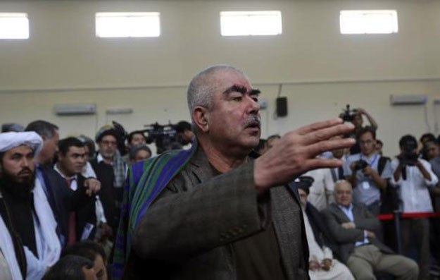 abdul rashid dostum an uzbek leader and a vice presidential candidate talks with his supporters at the afghanistan 039 s independent election commission iec in kabul october 6 2013 photo reuters