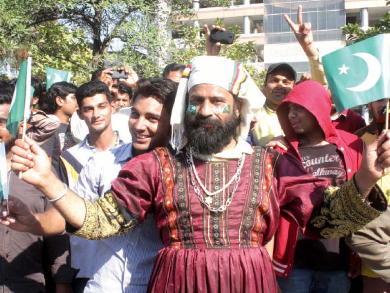 participants waving national flags at the float parade photo abid nawaz express