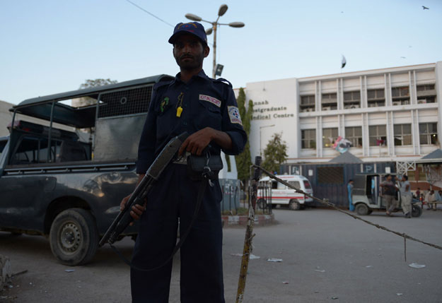 a private security personnel stands guard outside the jinnah postgraduate medical centre jpmc in karachi on march 23 2015 photo afp