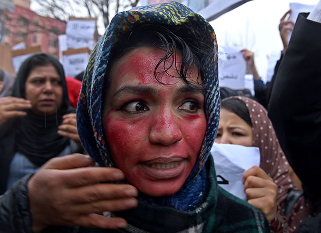 an afghan female protester her face painted red to depict farkhunda 039 s bloodied face shouts slogans with others during a rally in front of the supreme court in kabul on march 24 2015 held to protest the killing of afghan woman farkhunda photo afp